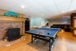 Lower level game room with access to side patio and tennis court
